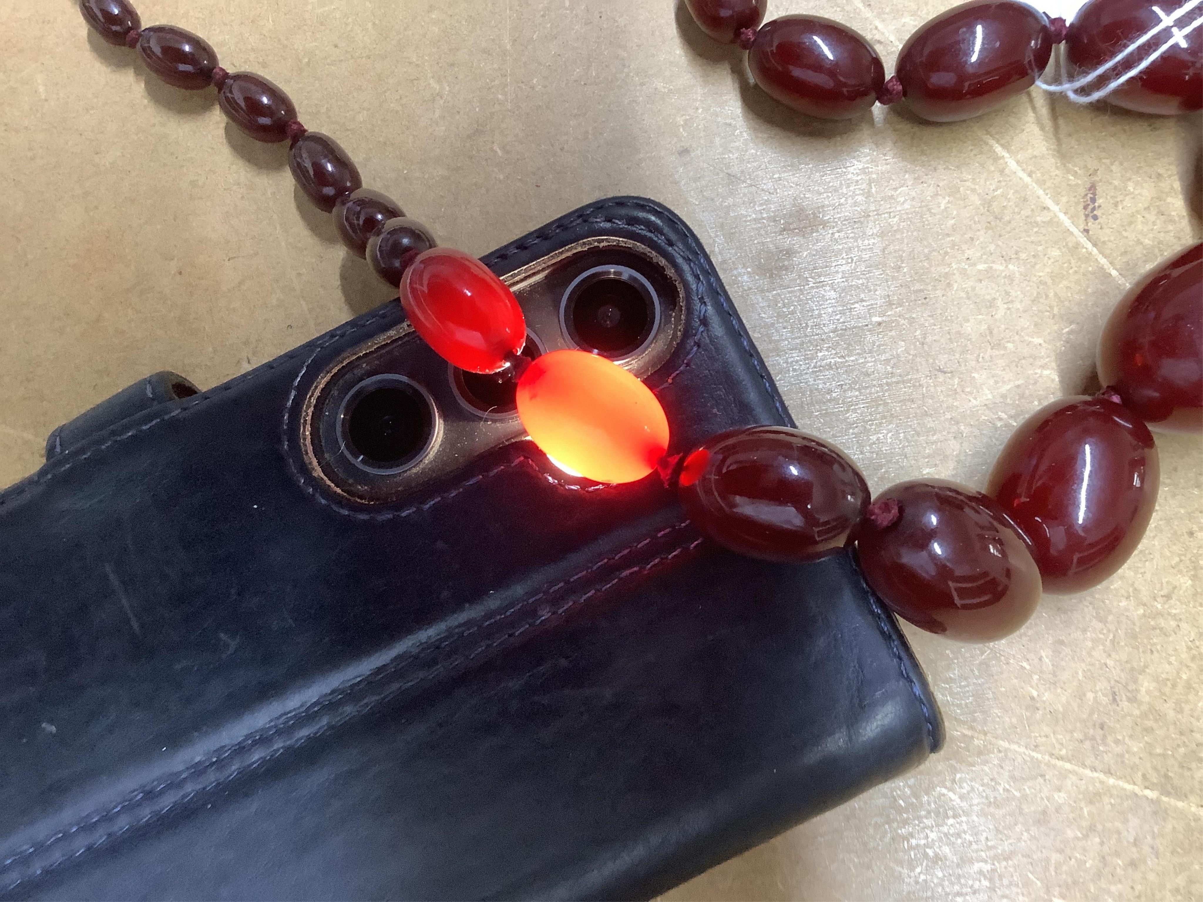 A single strand simulated cherry amber bead necklace, with graduated oval beads, 72cm, gross weight 73 grams.